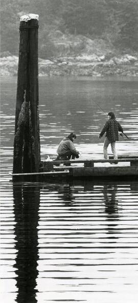 Kylee Wallace (left) and Mike Mitchell fishing off dock at Bellcara Park Monday.