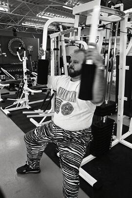 Man using pec deck exercise machine