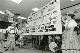 Fran Dowie (with the sticks) organizer of Oktoberfest in Westwood leads the crowd in a bizarre German sing-a-long.