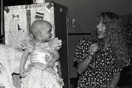 Angela Straham, former Miss PoCo sings "Wind beneath my Wings" to Chelsea at fundraiser birthday party at the Lighthouse Restaurant.